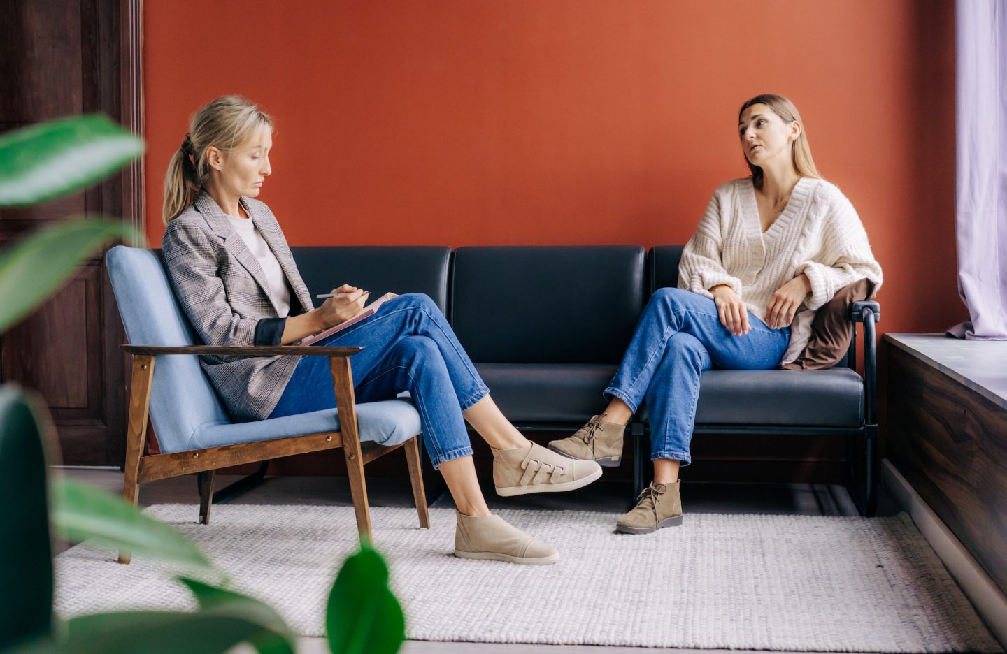 a-female-psychotherapist-attentively-listens-and-counseling-a-young-woman-talking-about-problems-.jpg